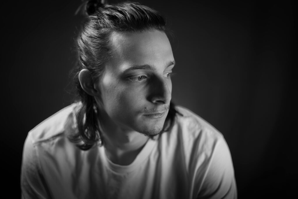 A man sitting, looking sad and thinking