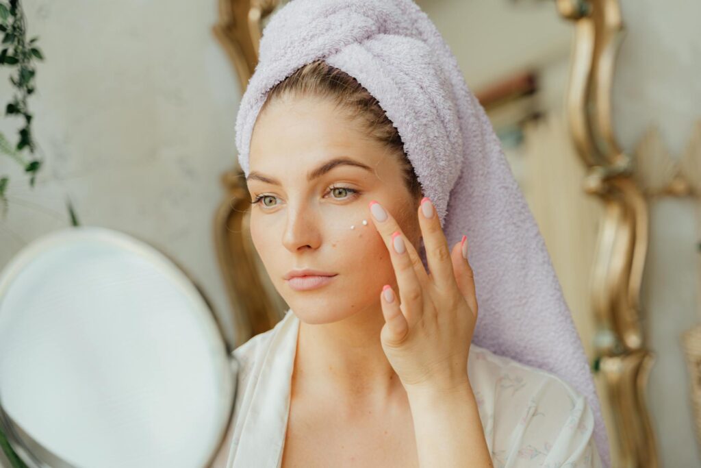 Woman doing skincare on her face an anti aging skin guide