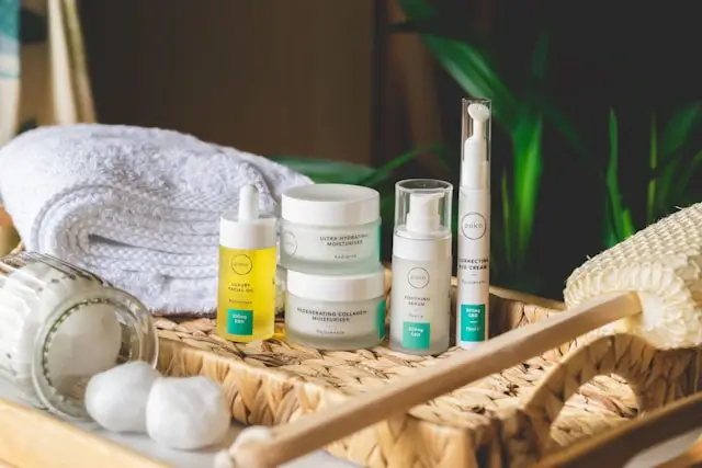 Anti-aging skincare products arranged on a woven tray with a towel and decorative cotton, representing a skincare morning routine for women over 50.