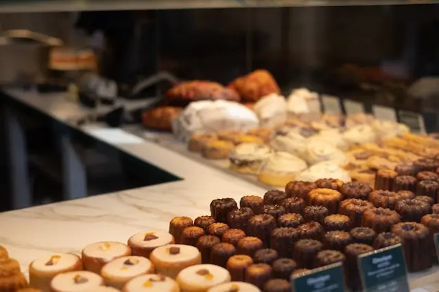 Display of assorted pastries, cookies, and other sugary baked goods in a bakery, illustrating common sources of added sugar to consider when following a 30-day sugar detox plan.
