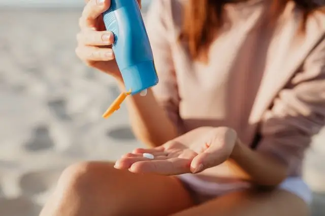 A person applying moisturizing sunscreen, illustrating the essential morning SPF step for skin over 40