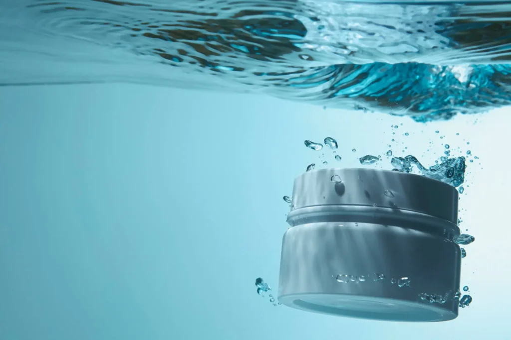 Marine collagen supplement jar submerged in clear water with bubbles, representing liquid marine collagen for skin health, hydration, and anti-aging benefits.