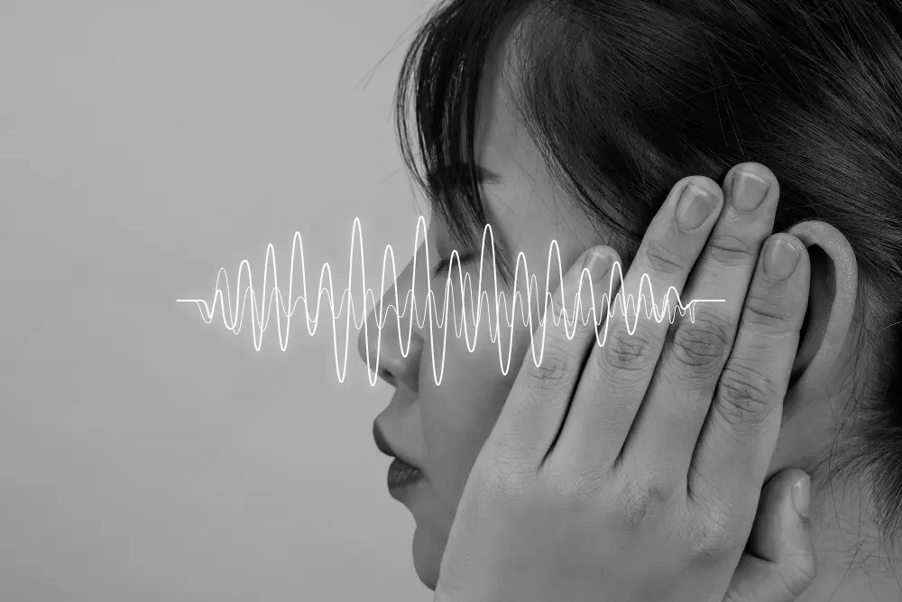 Woman covering her ear with a visible soundwave overlay, symbolizing hearing issues, tinnitus, and the need for natural hearing support supplements, as audifort