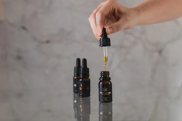 A minimalist, luxury aesthetic showcasing dropper bottles containing blue-tinted copperpeptide serums or clean, clinical cosmetic formulations.