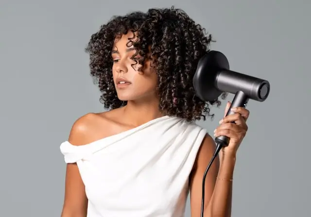 Woman with curly hair following a personalized scalp care routine.