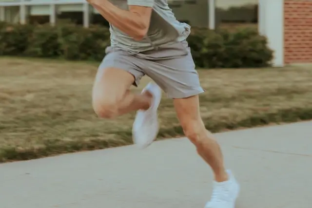 Man over 40 running outdoors on a sidewalk, illustrating cardio exercise for healthy testosterone levels.